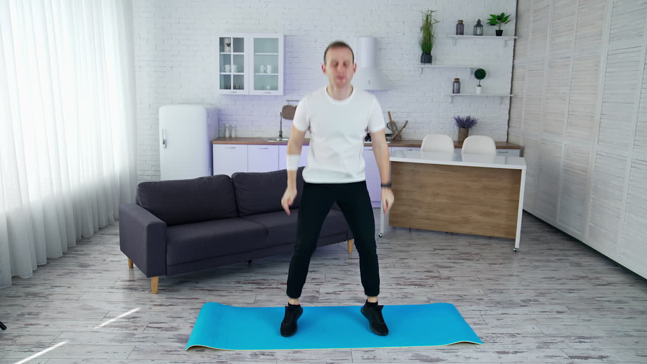 Quarantine man doing exercise indoor. Lifestyle strong man training his body in home.