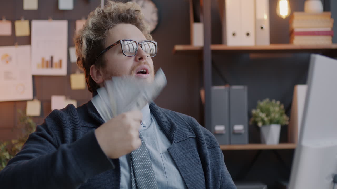 Man Blowing Money in Office