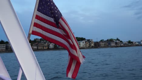 united states flag waving across the sky at dusk