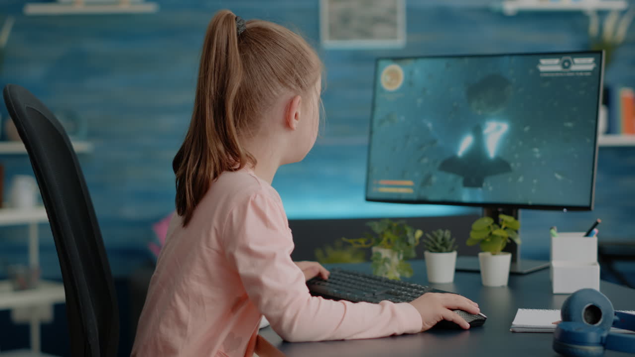 Schoolgirl using computer to play video games for entertainment