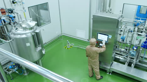 technician or scientist in uniform work in high-tech stainless steel industrial processing tank control panel for automation, advanced industrial equipment production pharmaceutical biopharmaceuticals