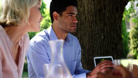 Friends-interacting-with-each-other-at-restaurant