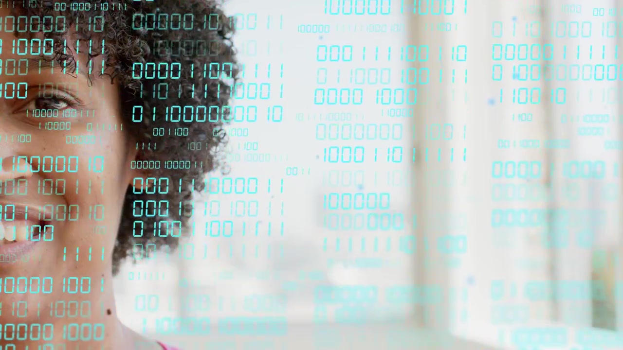 Woman speaking and smiling while teal binary scrolling over windows partly hiding face for tech