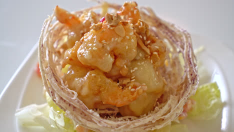 fried shrimp with salad and fried taro basket topped by salad cream and mayonnaise