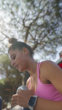 woman exercising outdoors with a kettlebell