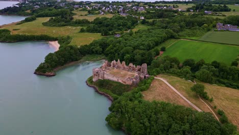 château du guildo, castle along coast, france. aerial drone tilt-down forward