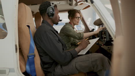 female pilot talking to technician during preflight aircraft check