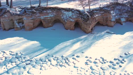 drone flight over the sea in winter frozen rocks on the coast