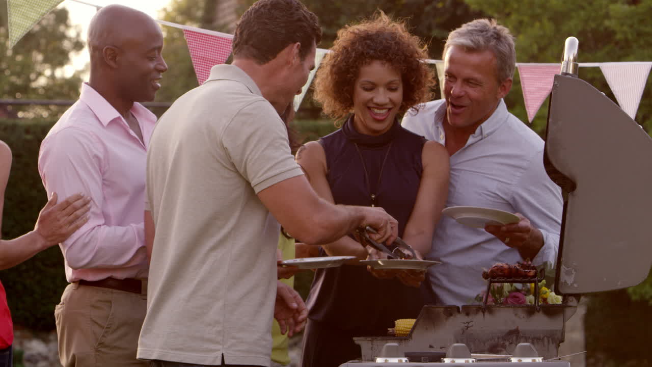 Mature Friends Enjoying Outdoor Barbeque Shot On R3D