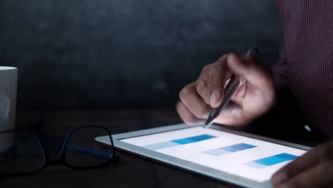 person reviewing data on tablet at night