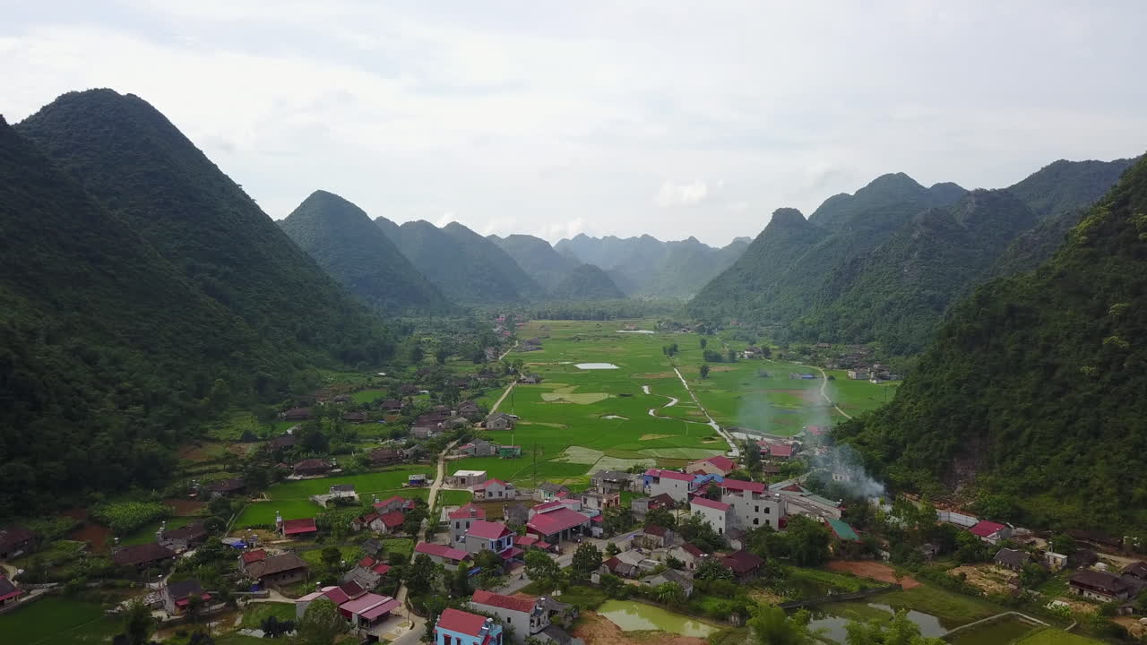 Aerial view of Bac Son Valley, lush green fields under cloudy skies