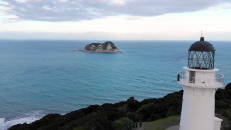 Aerial-reveal-of-East-Cape-Lighthouse,-stunning-coastal-scenic-spot-in-New-Zealand