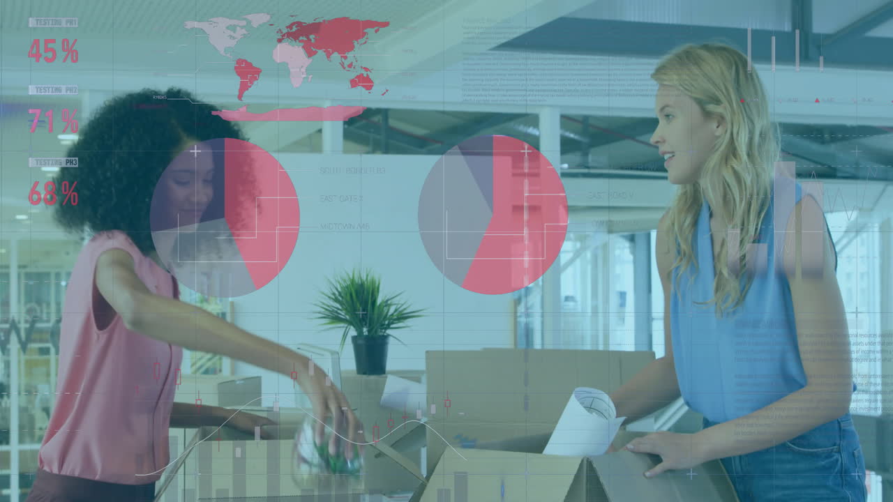 Two women unpacking boxes in business office, interacting with animated pie charts and world map