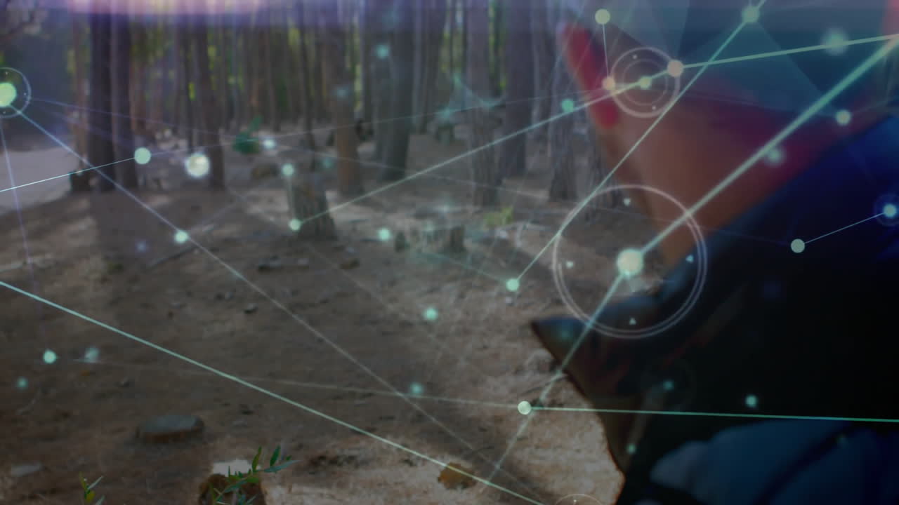 Male moving along pine forest trail with digital network graphics highlighting technology theme