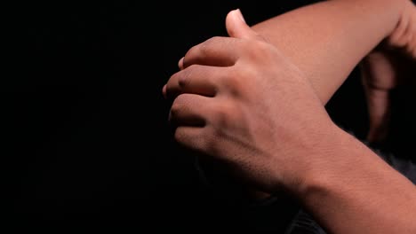 close-up of a person examining or massaging their elbow and arm