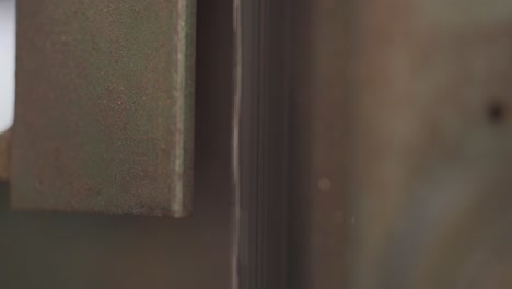 macro shot of a operational bandsaw blade, machine for manufacturing production