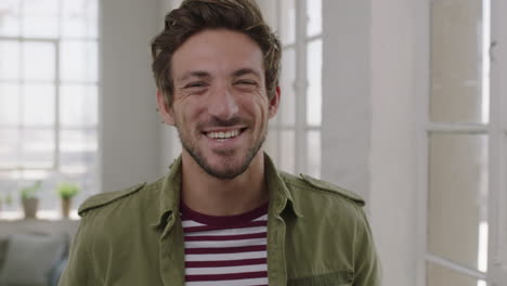 close up portrait of handsome young man laughing cheerful enjoying lifestyle happy caucasian guy in apartment background