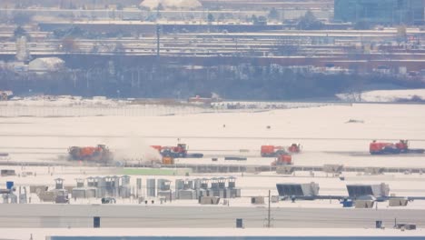 line of specialized snow removal heavy machinery leave depot to clear roads after storm in toronto, static telephoto