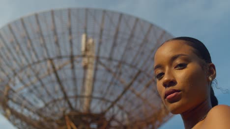 Epic-facial-close-up-of-a-model-with-a-radar-tracking-station-in-the-distance-on-the-Caribbean-island-of-Trinidad