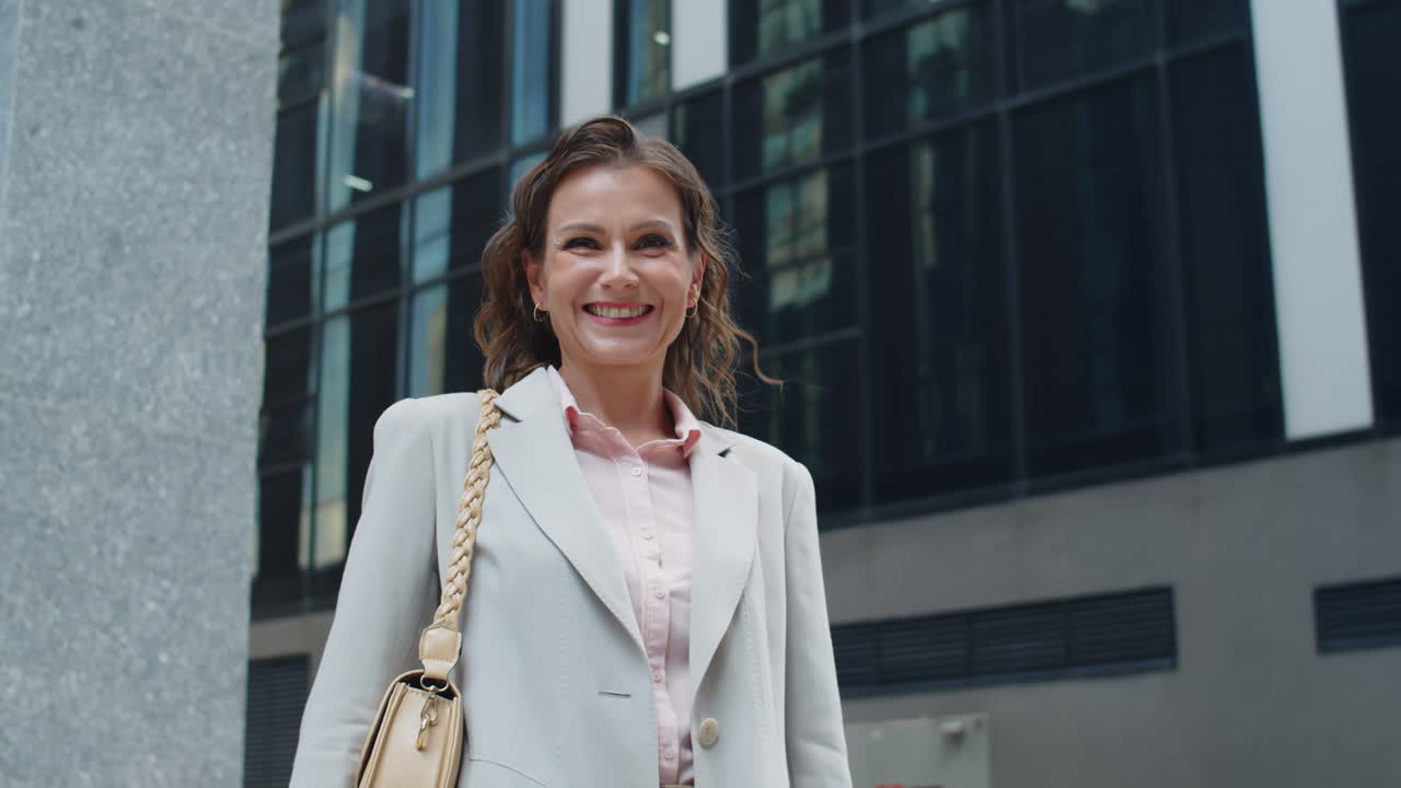 Businesswoman Posing for Camera against Office Building Background