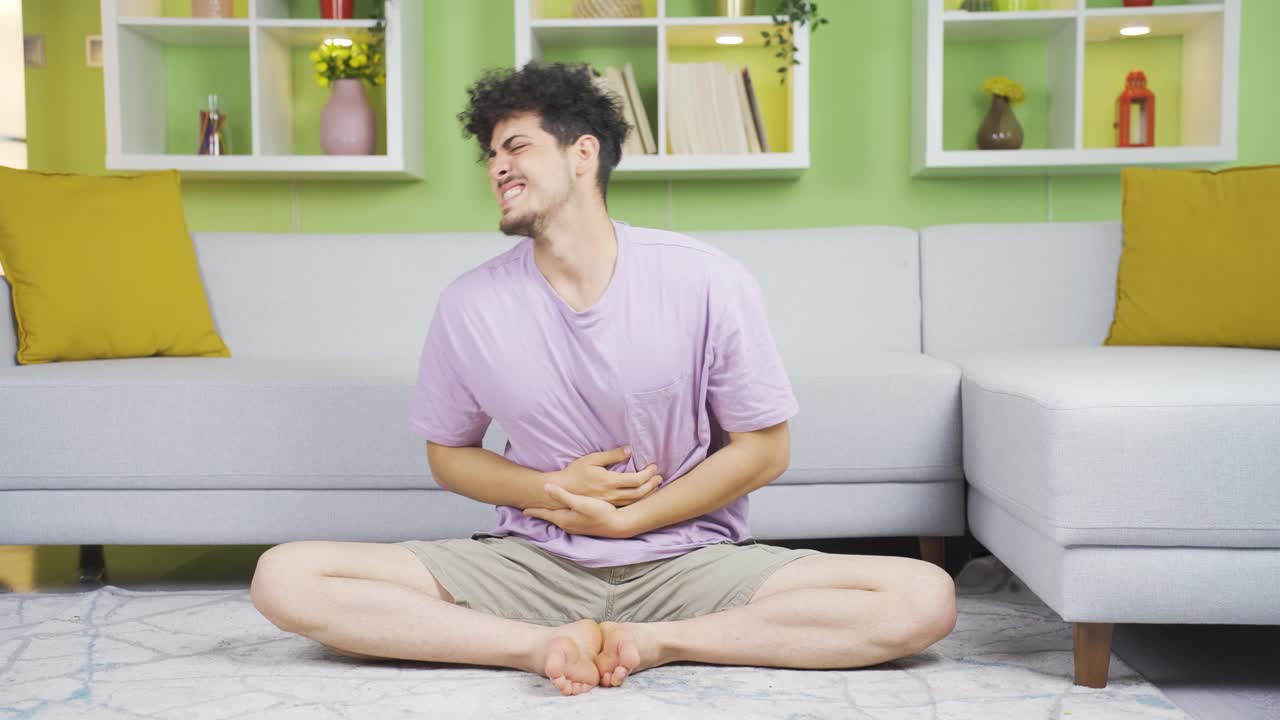Young man having stomachache.