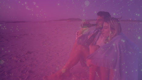 sitting on beach, couple watching animation with sparkling pink overlay