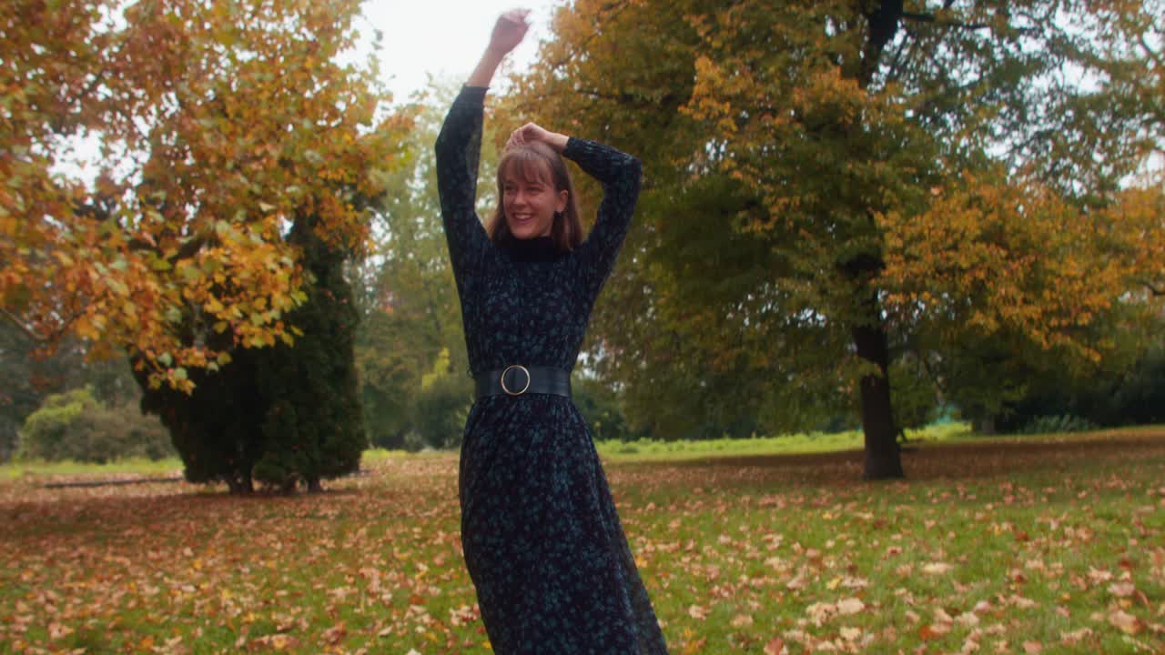 happy girl dancing in autumn park, poetry, smiling woman, freedom dance, slow motion, slomo.