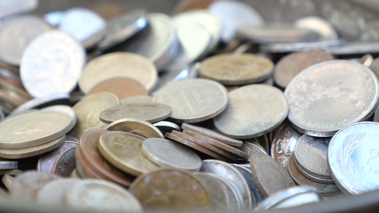 Various Coins Falling and Accumulating in a Pile