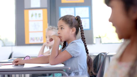 Biracial girl in a classroom setting in school, in a classroom