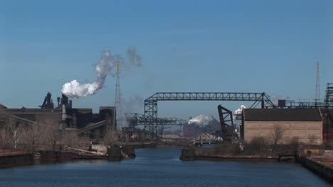 construction equipment and skeleton of a new structure spanning a river