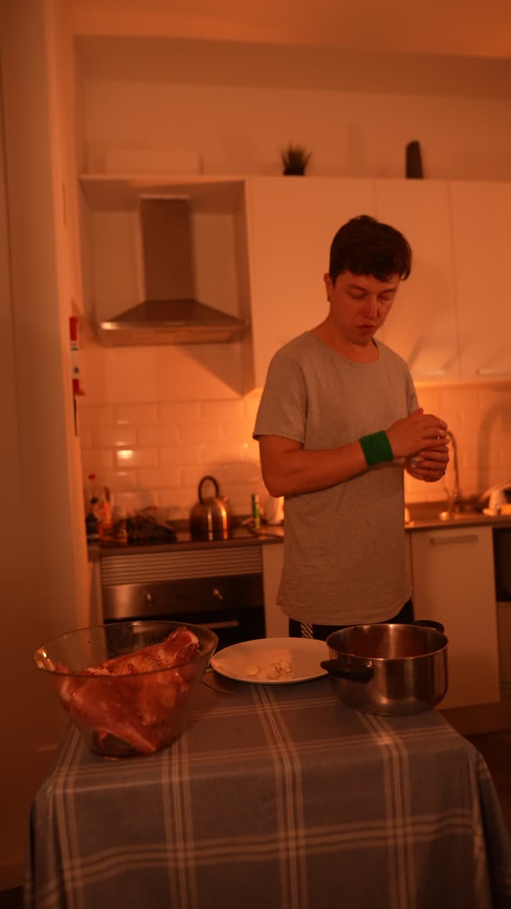Man preparing pork ribs in a kitchen