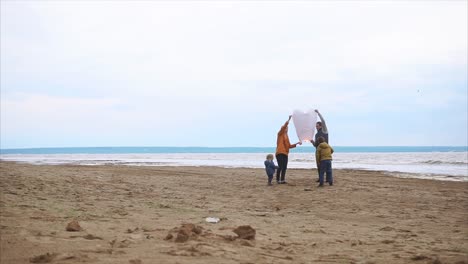 family launching a sky lantern on the beach