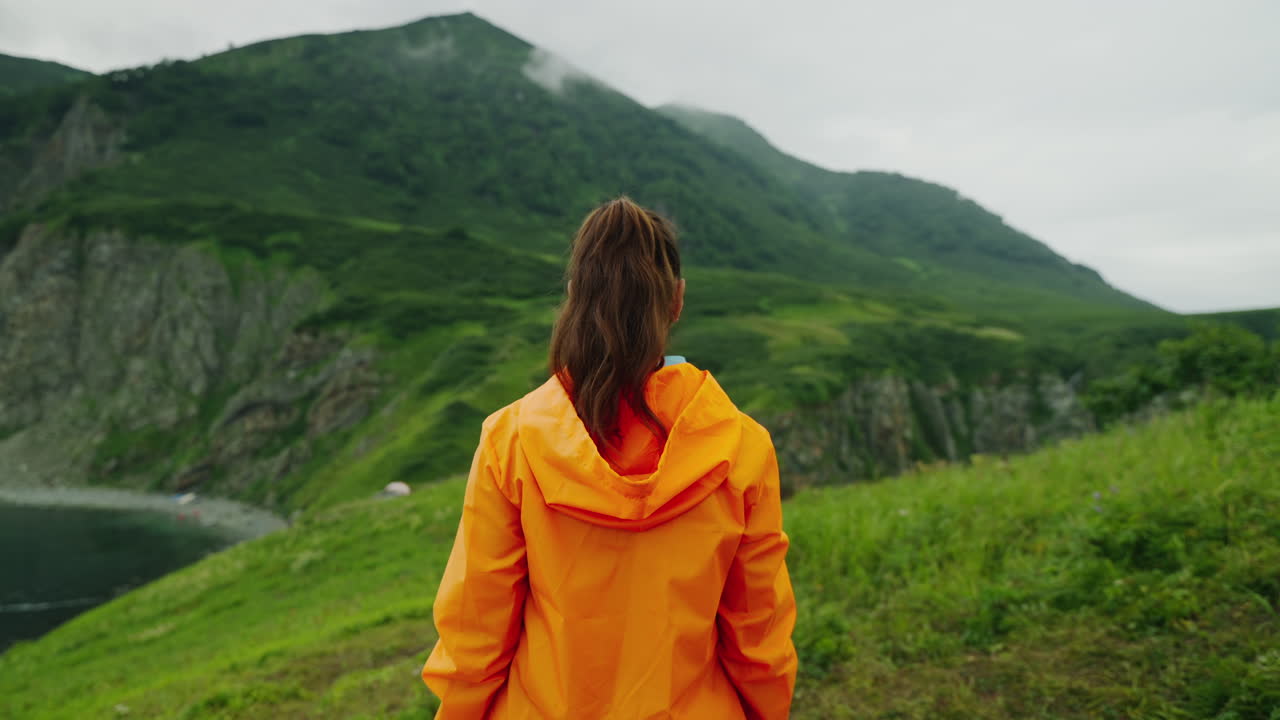 Woman Hiking in Mountains with Cloudy Weather