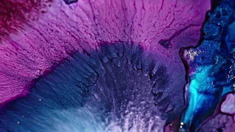 close-up of vibrant purple and blue ink diffusing in water, creating an abstract pattern