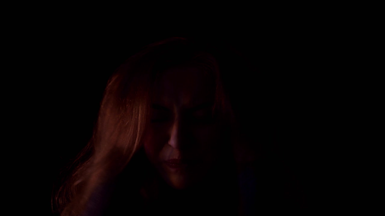 Schizophrenia. The young woman suffers from a mental illness, schizophrenia. She has fears and feels shattered. She screams in terror in the flashing light