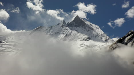 aerial drone shot of a cloudy snowy peak in the annapurna mountains, nepal