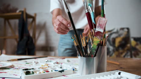 woman choosing paintbrush