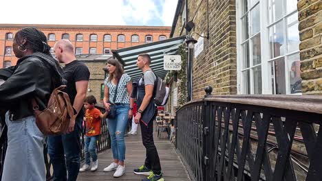 pedestrians on a bridge in camden town