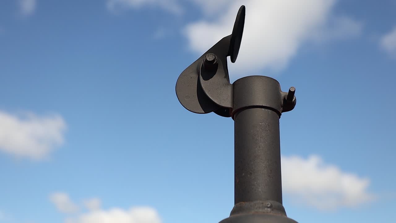 Low angle of heavy duty equipment exhaust pipe vibrating against sky