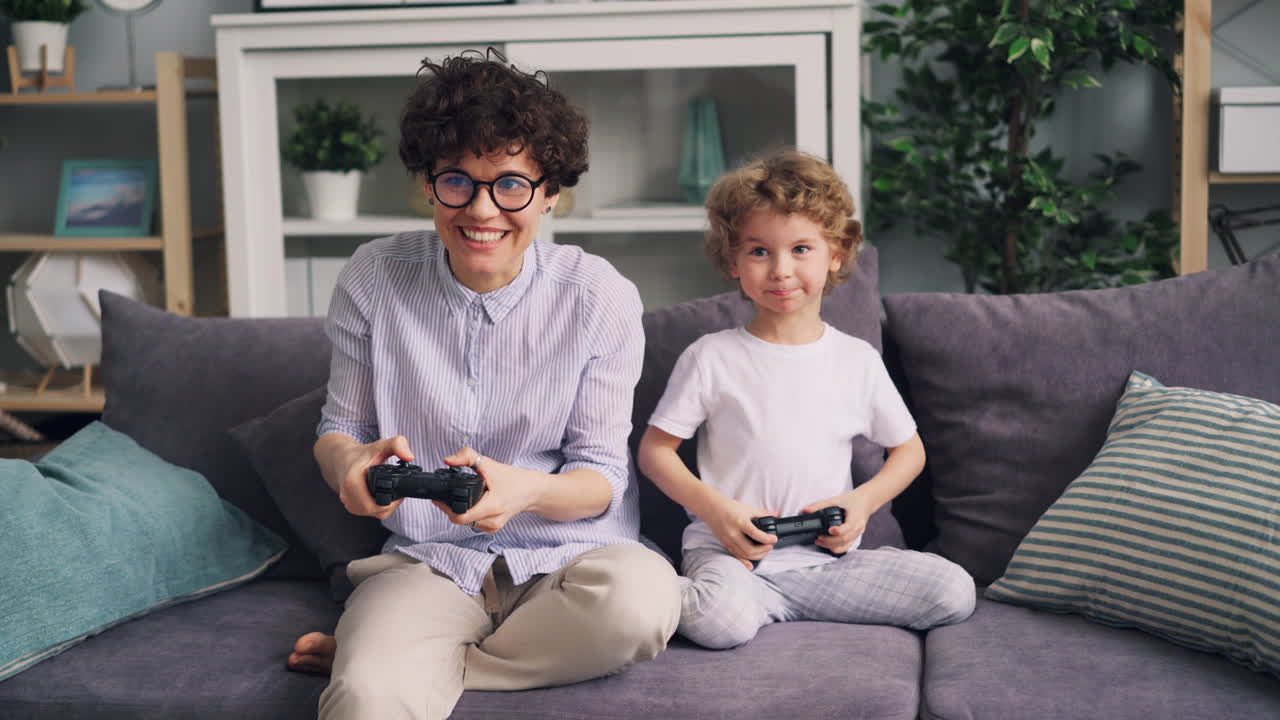 Mother and Son Playing Video Games Together at Home