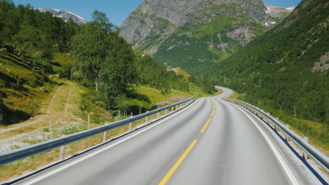 go along the scenic road among the mountains of norway first-person view