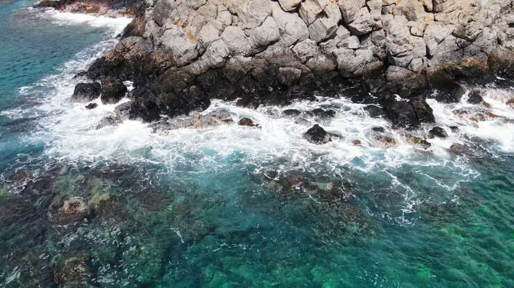 Slow pan up from the ocean to mountains in Maui, Hawaii