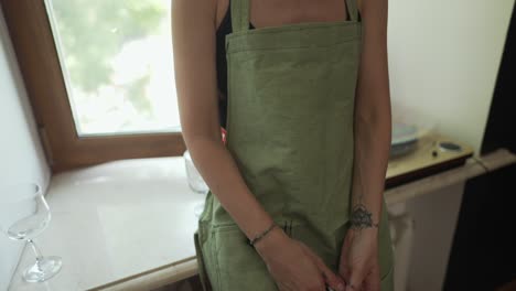 young artist in apron, holding a lot of painting brushes