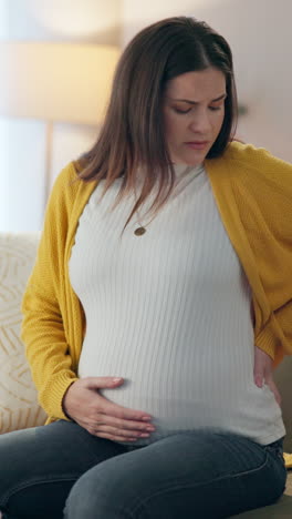 pregnant woman holding her stomach in pain