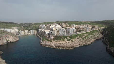 Aerial-View-Of-A-Rocky-Shoreline-In-Xlendi-Bay,-Malta
