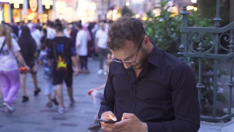 Teenager-using-phone-in-crowd.