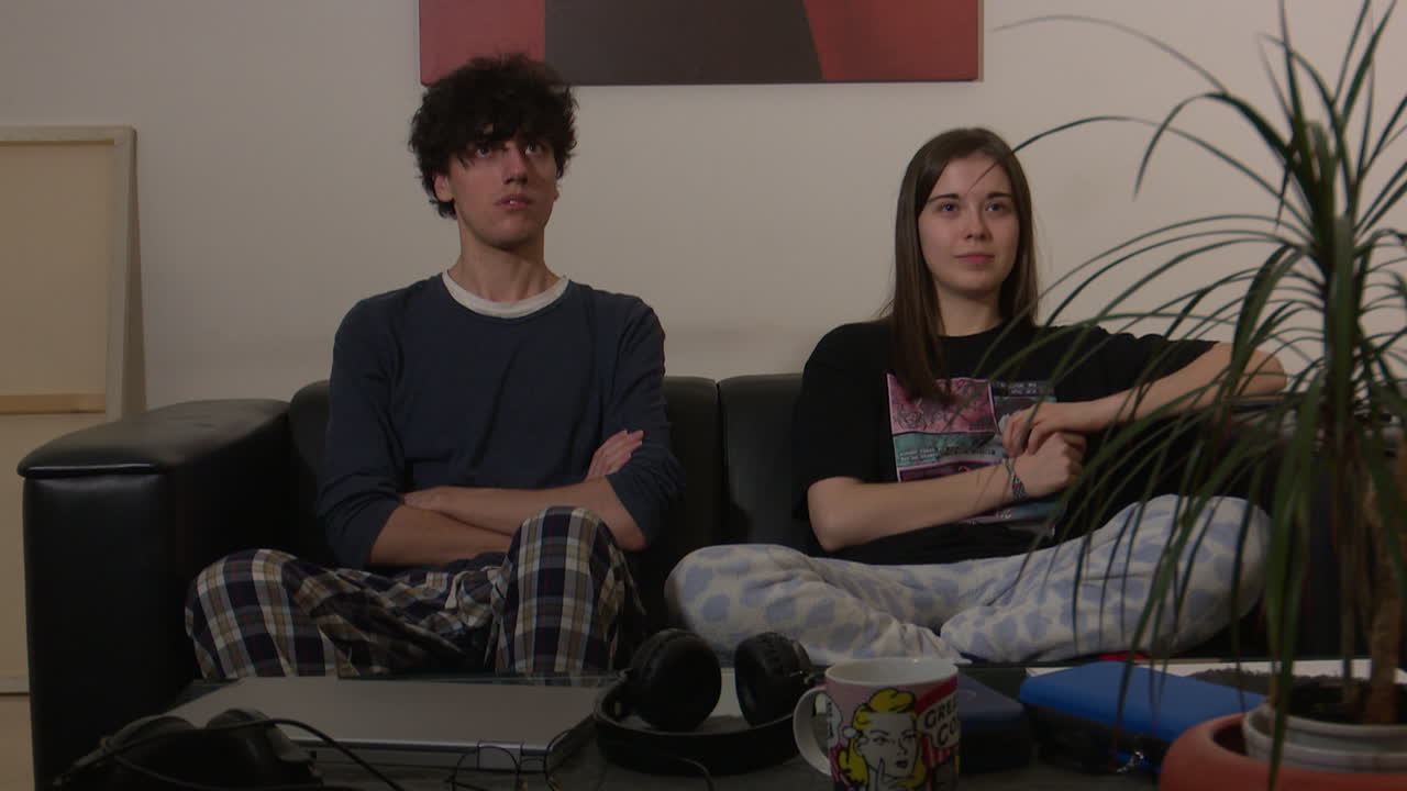 Young Adults Relaxing on a Sofa