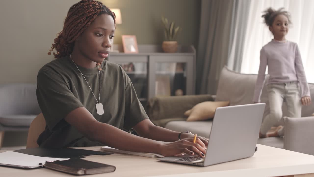 Female Soldier Working on Laptop from Home