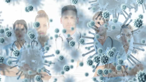 animation of 3d covid 19 cells floating over portrait of group of doctors