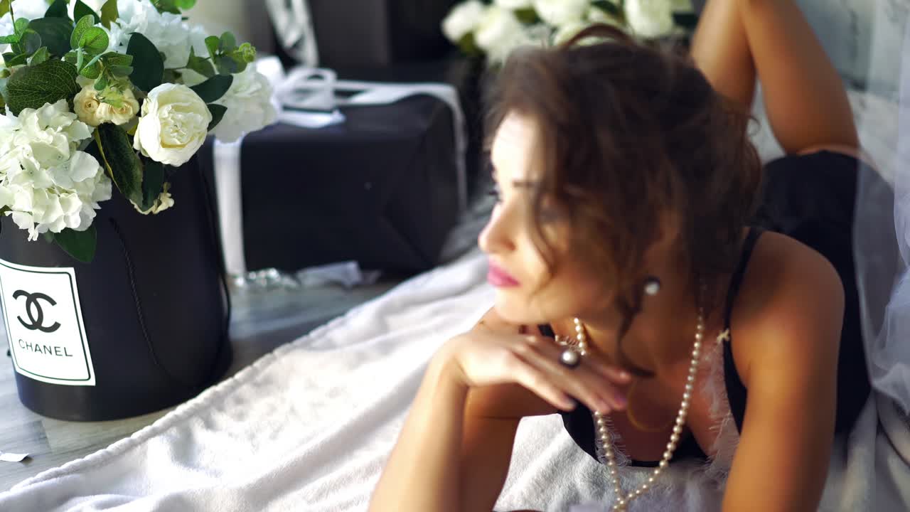 Beautiful woman is relaxing on floor. Beautiful woman in black underwear is relaxing on floor